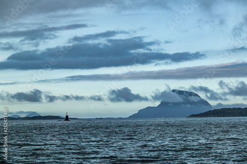 sea and landscape with steep mountains and dramatic cloud sky in the  fords of middle Norway  Scandinavia