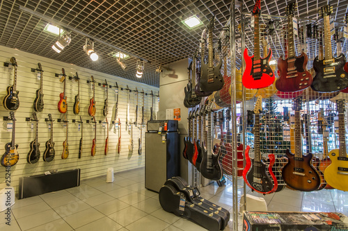 Rows of acoustic guitars on the wall