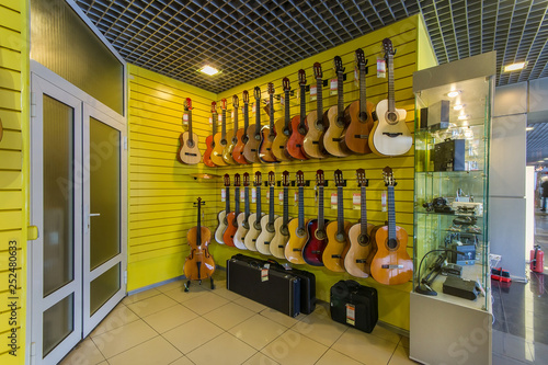 Acoustic guitars hanging in a modern musical shop
