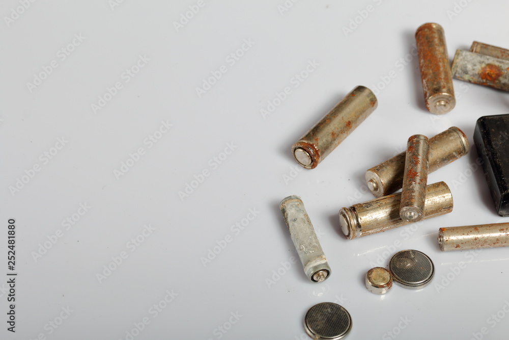 Used batteries on a white background. Recycling waste batteries. Environmental Protection. Earth Day. Used batteries on a white background. Recycling waste batteries. Environmental Protection. Earth Day.