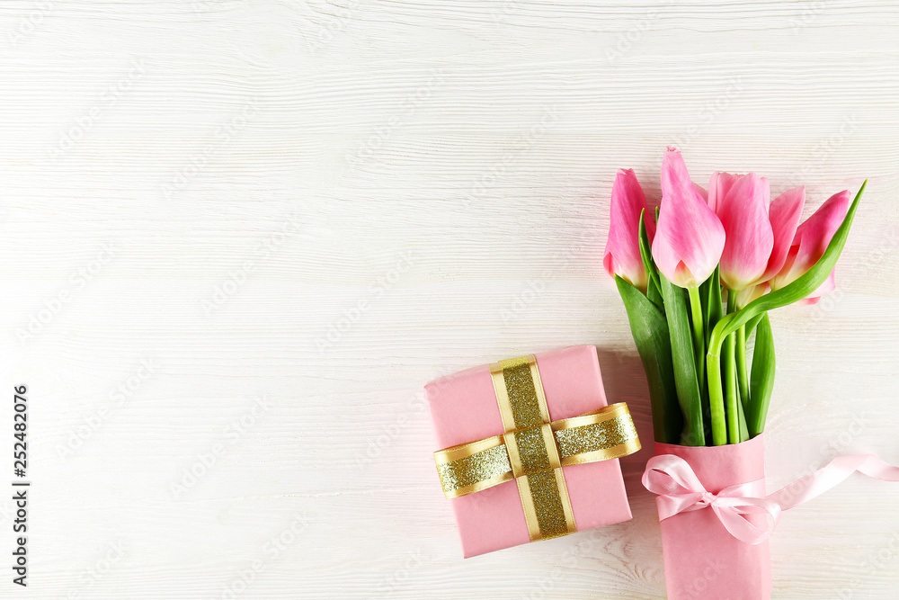 Fresh flower composition, bouquet of bi color pink tulips, white wooden texture table background. International Women's day, mother's day greeting concept. Copy space, close up, top view, flat lay. Fresh flower composition, bouquet of bi color pink tulips, white wooden texture table background. International Women's day, mother's day greeting concept. Copy space, close up, top view, flat lay.
