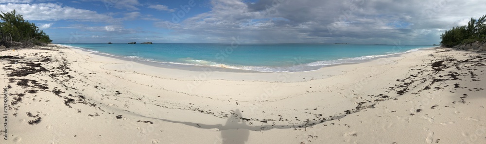 Panoramic view of a beautiful stretch of white sand beach in the Bahamas