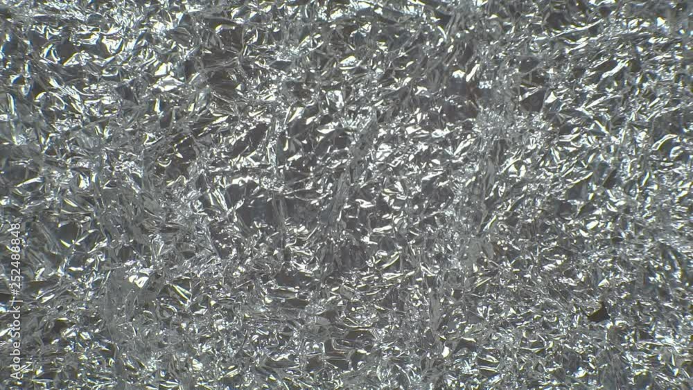 Texture of crumpled aluminum foil in motion.Camera movement from left to right. 1920X1080 Full Hd. Texture of crumpled aluminum foil in motion.Camera movement from left to right. 1920X1080 Full Hd.
