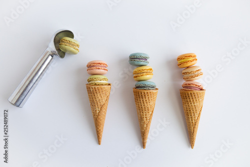 Colorful macaron cookies in sugar ice cream cones