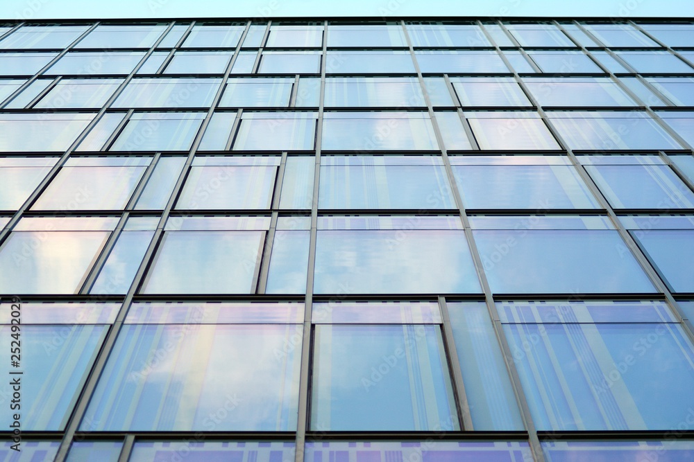 The windows of a modern building for offices. Business buildings architecture. The windows of a modern building for offices. Business buildings architecture.