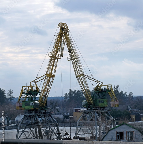 Cranes at work in the winter on the river