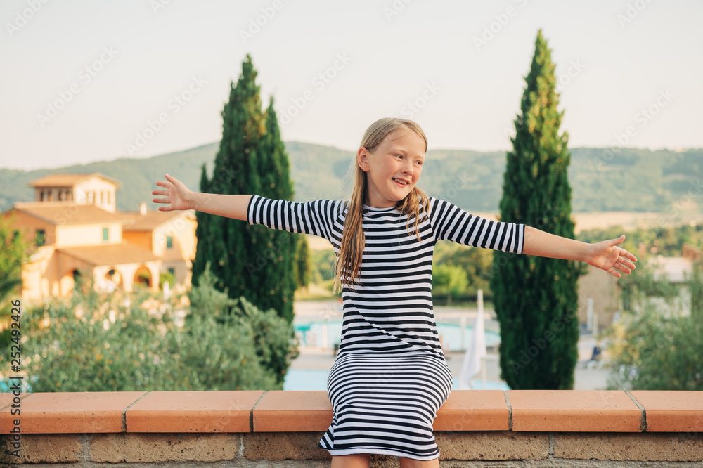 Outdoor portrait of a cute little girl of 8 years, image taken in Italy, Tuscany