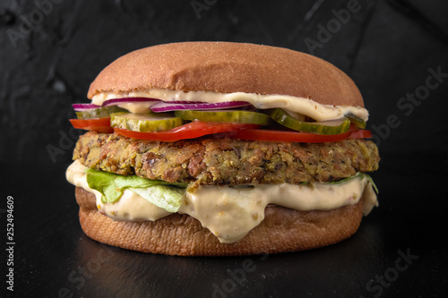 Juicy fresh Vegetarian hamburger with falafel cutlets and vegetables. The burger menu.