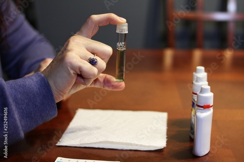 Person testing water pH balance for fish tank.