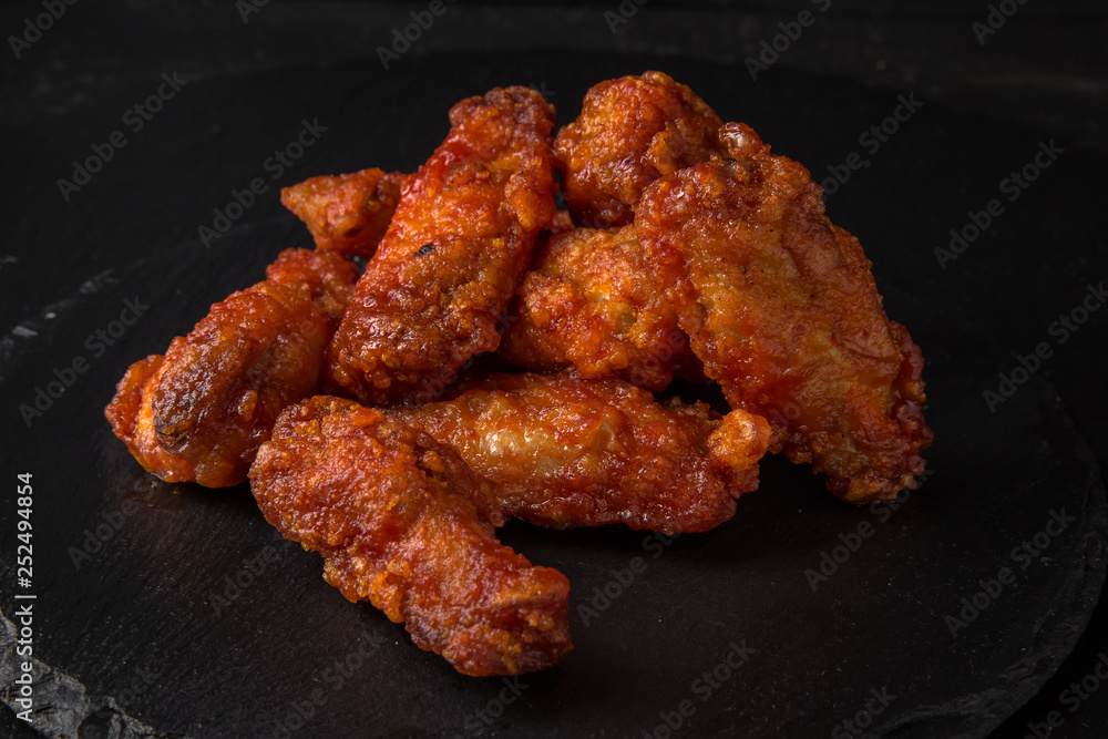 Spicy Wings on black background. Snack to beer. Fast food. Spicy Wings on black background. Snack to beer. Fast food.