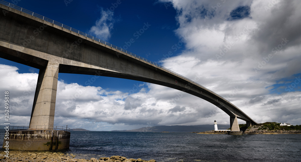 Fototapeta premium Skye Bridge to Isle of Skye over Kyle Akin Strait from Inner Sound to Loch Alsh and Eilean Ban Island with white Kyleakin lighthouse Scotland