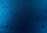 Drops of water on a blue glass texture background