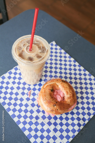 bagel with strawberry cream cheese and iced coffee