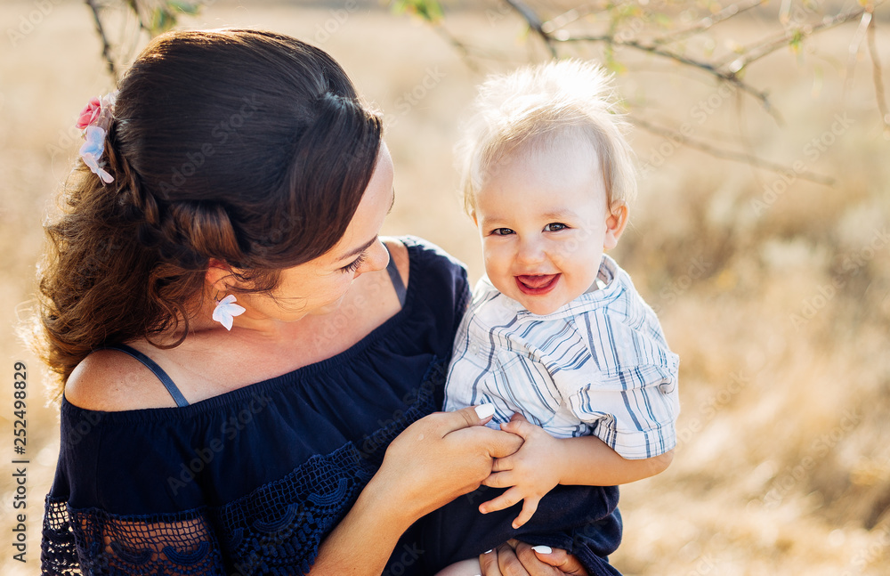 Fototapeta premium Portrait of a young mother with his son