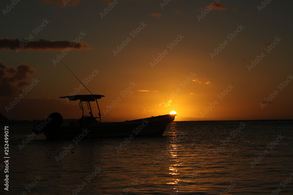 Silhouette of boat at sunset