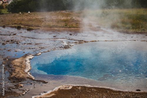 The colorful geyser landscape at the Haukadalur geothermal area at summer season