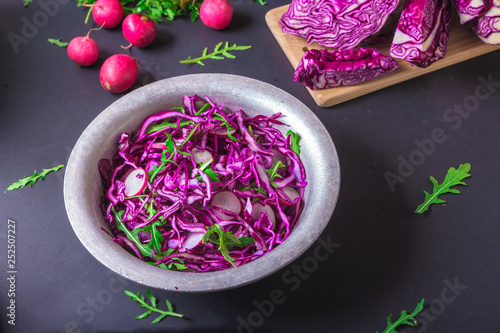 Healthy salad with red cabbage, radish and arugula . Vegetarian concept