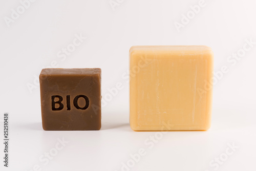 two pieces of natural soap isolated on a white background