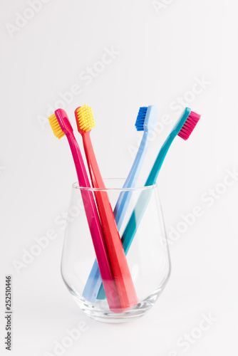 Cup with toothbrushes isolated on white background. Dental care