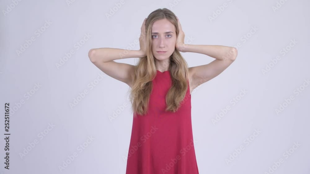 Young beautiful blonde woman covering ears as three wise monkeys concept Young beautiful blonde woman covering ears as three wise monkeys concept