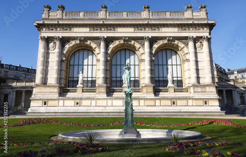 Blue sky and green grass the perfect backdrop for beautiful old architecture and fountain statue at the Square du Palais Galliera in Paris .