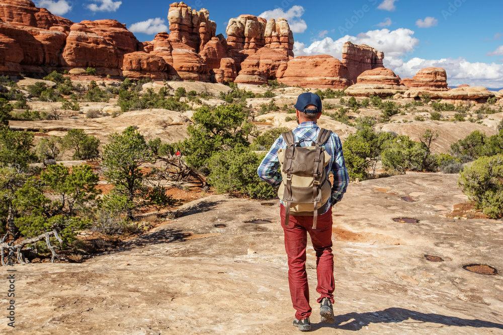 Hiker in Canyonlands National park, needles in the sky, in Utah, USA Hiker in Canyonlands National park, needles in the sky, in Utah, USA