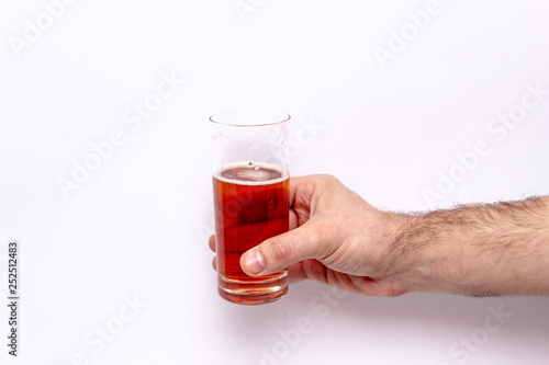 glass of beer in hand isolated on white background.