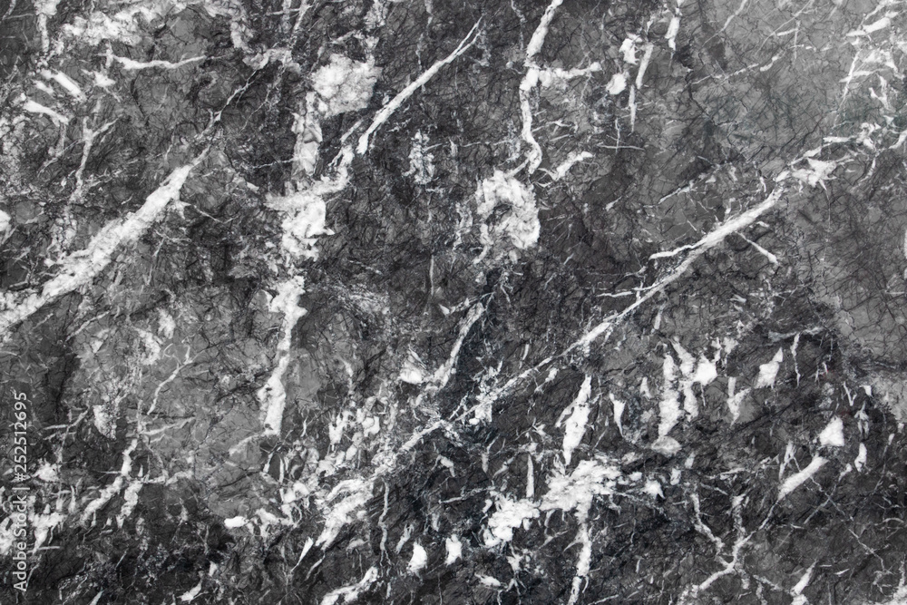 Black marble texture. Closeup photo of patterned granite wall