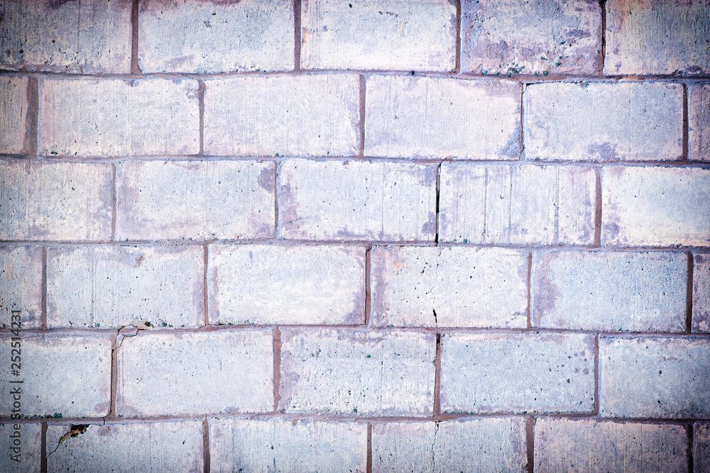 Light lilac wall made of large bricks. Blank background with brickwork texture. Light lilac wall made of large bricks. Blank background with brickwork texture.