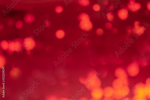 Abstract red background in blur. Lights and spots defocus.