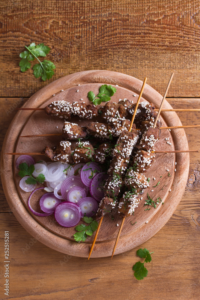 Beef liver on skewers with sesame seeds. Liver Kebab. View from above, top studio shot Beef liver on skewers with sesame seeds. Liver Kebab. View from above, top studio shot