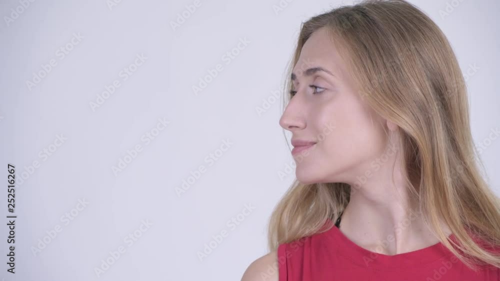 Face of happy young beautiful blonde woman smiling and looking away Face of happy young beautiful blonde woman smiling and looking away