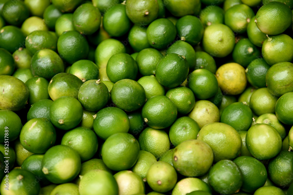 Full frame view of freshly harvested raw green Tahitian Limes, farmers produce market in Medellin, Colombia Full frame view of freshly harvested raw green Tahitian Limes, farmers produce market in Medellin, Colombia