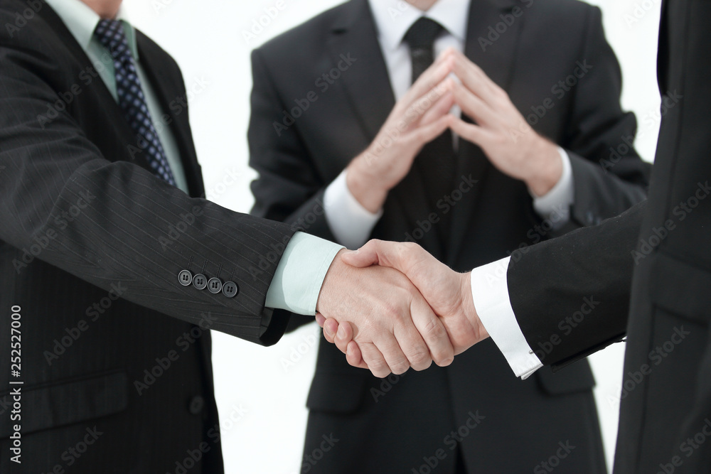 Closeup of handshake of two entrepreneurs wearing business suit Closeup of handshake of two entrepreneurs wearing business suit