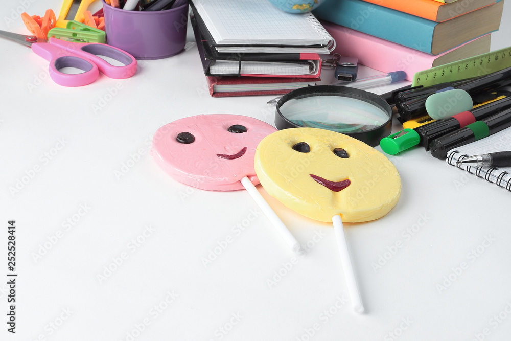 Fotografie two candy and school supplies on a white background