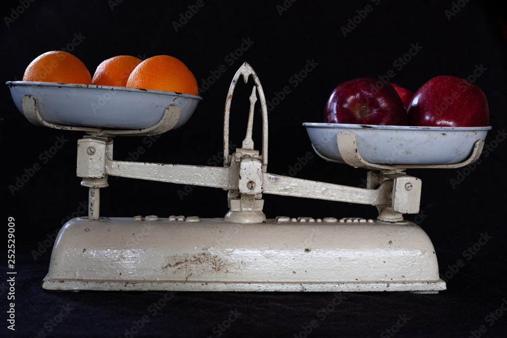 Fototapeta premium Apples vs Oranges on Black Backround