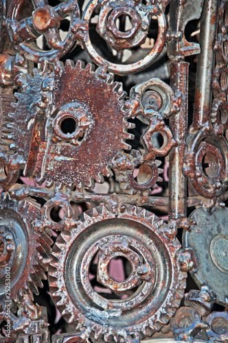 Old, worn, rough mechanical gears made of rusty metal. Design minimalism. Iron composition. Retro style. Stylish top and trendy design background round gears.