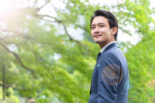 portrait of asian businessman in park
