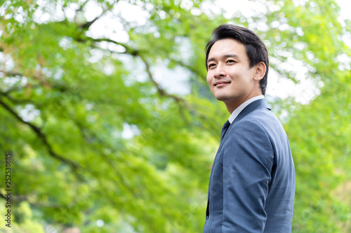 portrait of asian businessman in park
