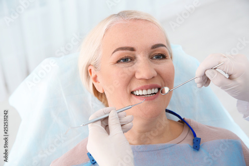 Fototapeta Naklejka Na Ścianę i Meble -  Dentist examining patient's teeth in modern clinic