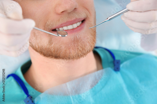 Fototapeta Naklejka Na Ścianę i Meble -  Dentist examining patient's teeth in modern clinic, closeup