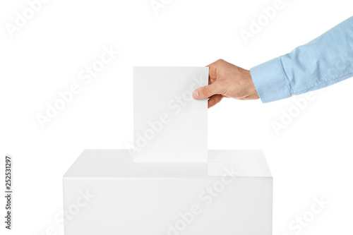 Man putting his vote into ballot box on white background, closeup