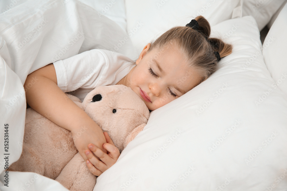 Beautiful little girl sleeping with toy in bed. Bedtime schedule Beautiful little girl sleeping with toy in bed. Bedtime schedule