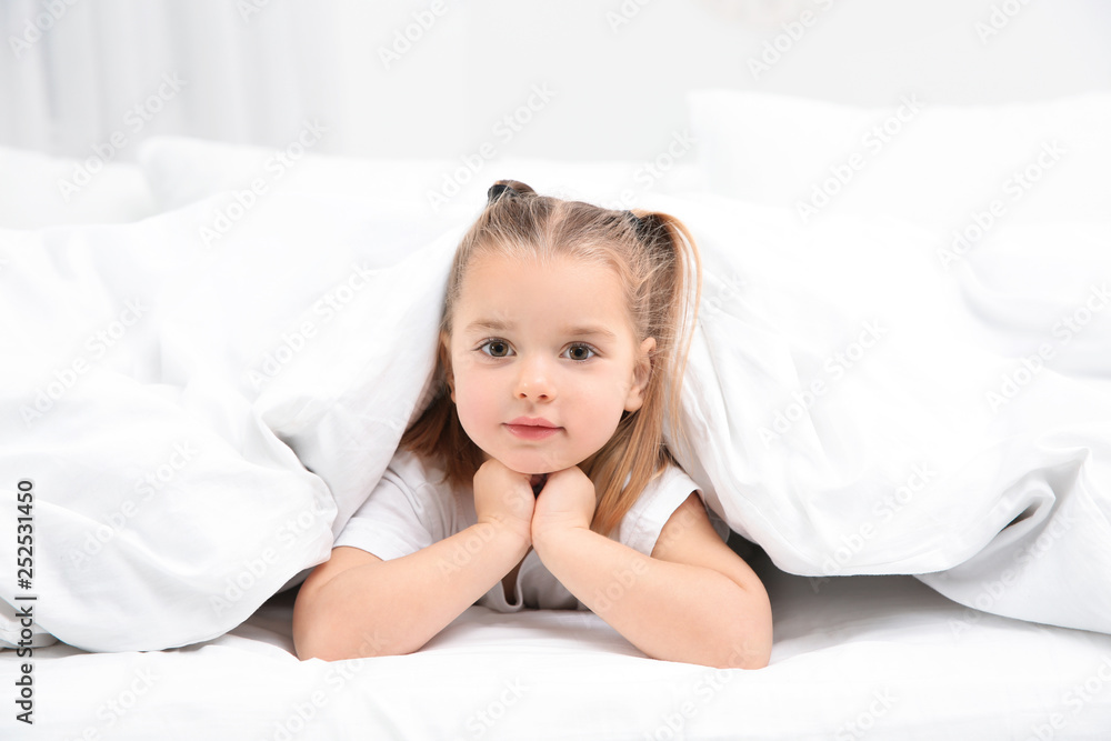 Beautiful little girl in bed at home. Bedtime schedule Beautiful little girl in bed at home. Bedtime schedule