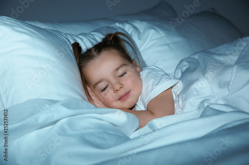 Beautiful little girl sleeping in bed at night. Bedtime schedule