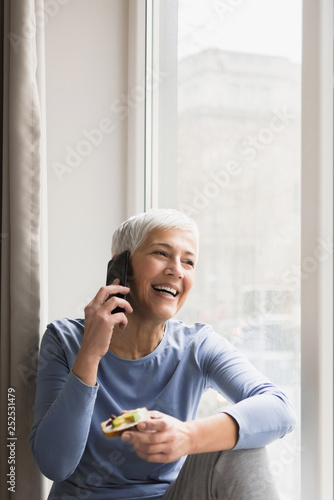 Mature woman talking on her phone photo