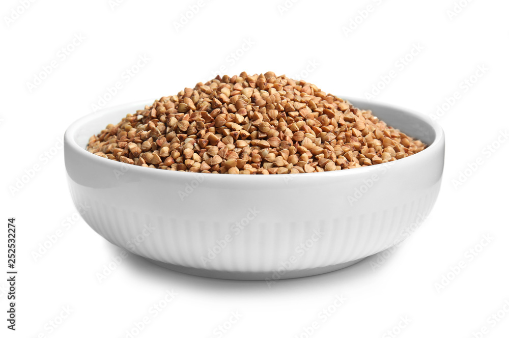 Bowl with uncooked buckwheat on white background Bowl with uncooked buckwheat on white background