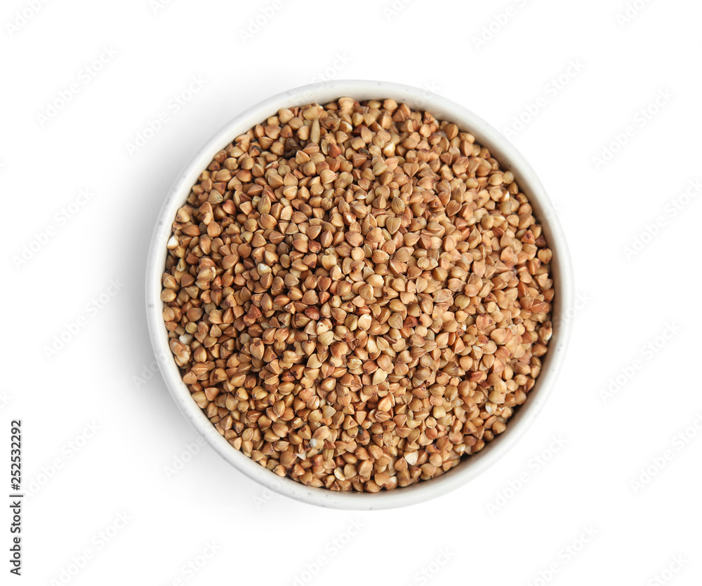 Bowl with uncooked buckwheat on white background, top view Bowl with uncooked buckwheat on white background, top view