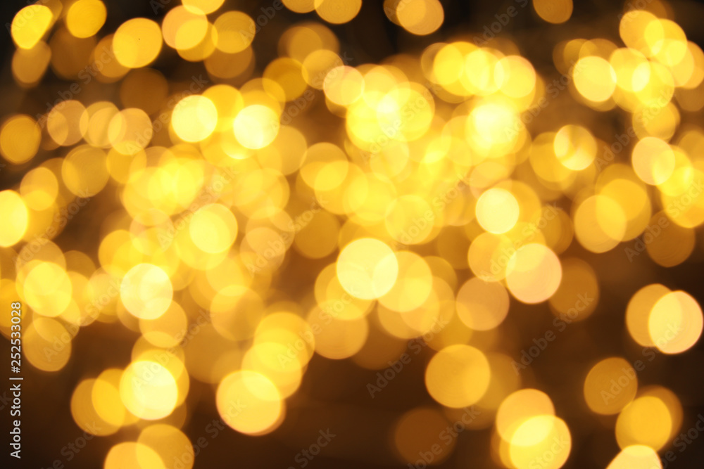 Gold glitter with bokeh effect on dark background Gold glitter with bokeh effect on dark background