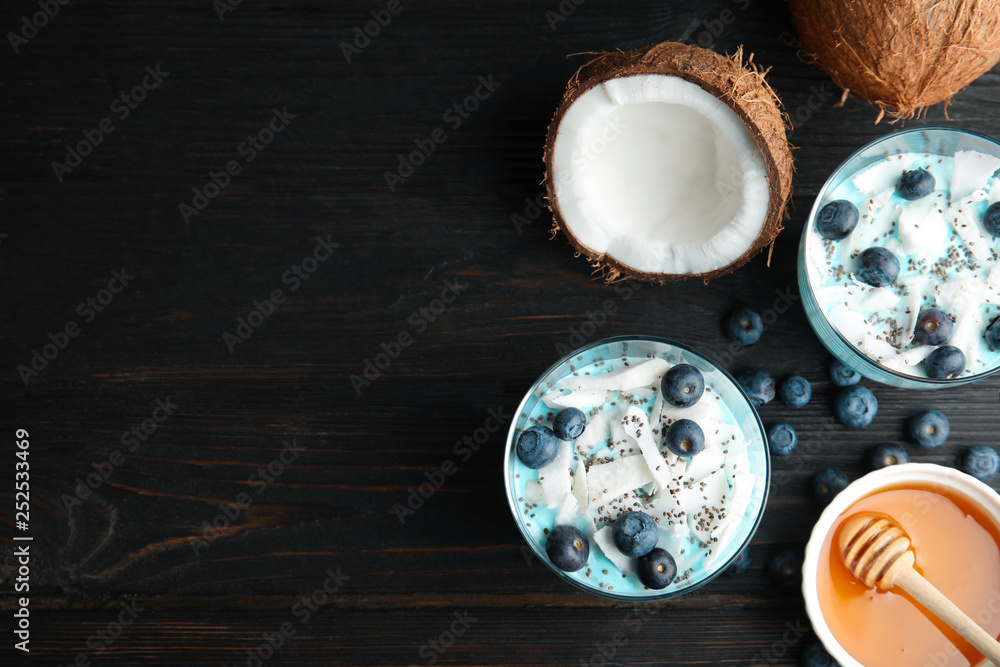 Flat lay composition with glass cups of spirulina smoothie and space for text on black background
